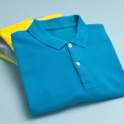 Three blue polo shirts set against a blue background