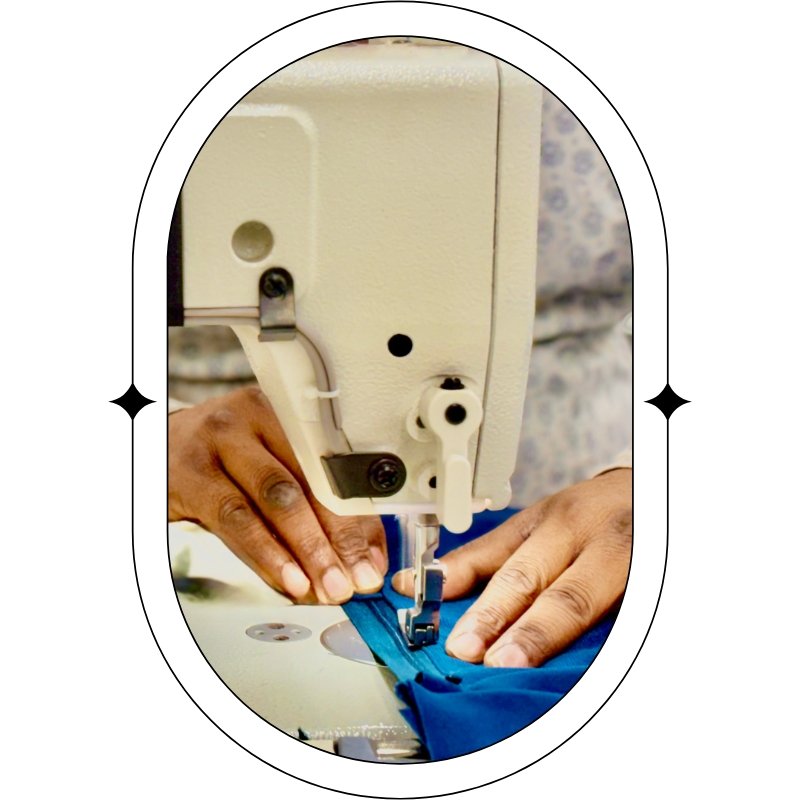 person sewing on blue fabric